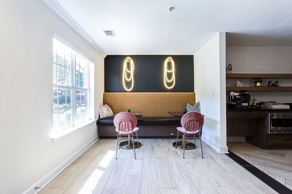 a lounge area with two chairs and a table in front of a window at Indigo Apartments Gainesville, Gainesville, 30504