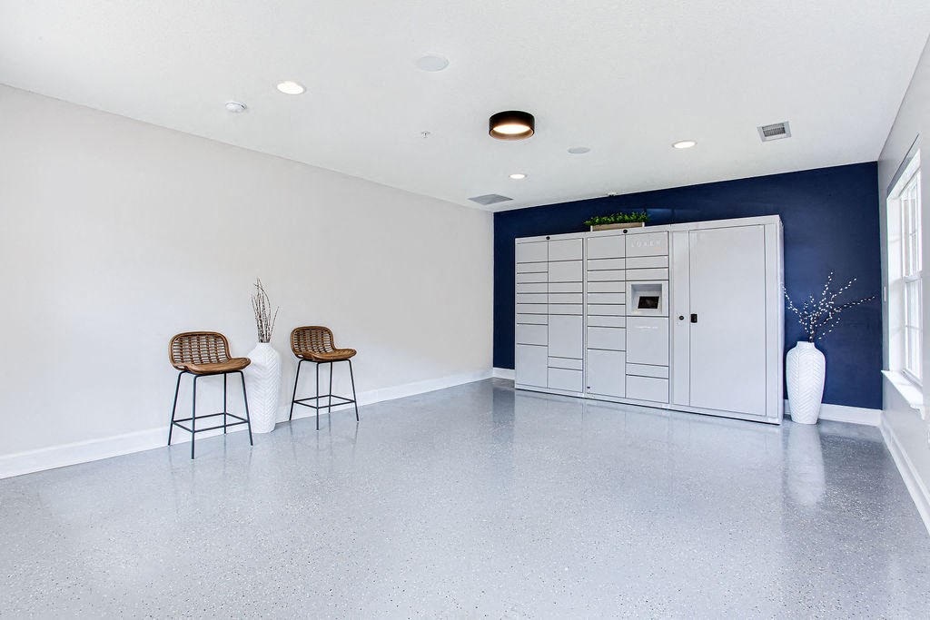an empty room with three bar stools and a white door at Indigo Apartments Gainesville, Gainesville Georgia