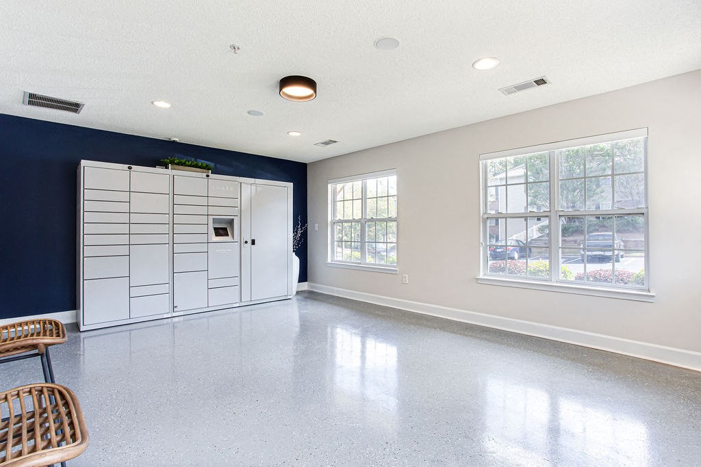 an empty room with a white and blue wall and a white door at Indigo Apartments Gainesville, Gainesville, GA 30504
