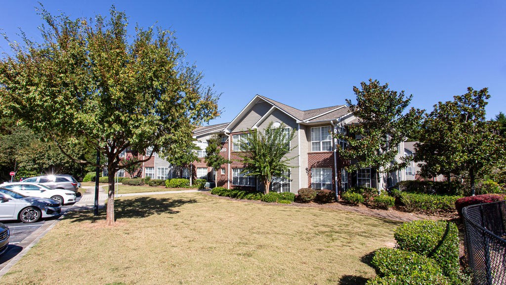 a yard in front of a row of houses at Indigo Apartments Gainesville, Gainesville