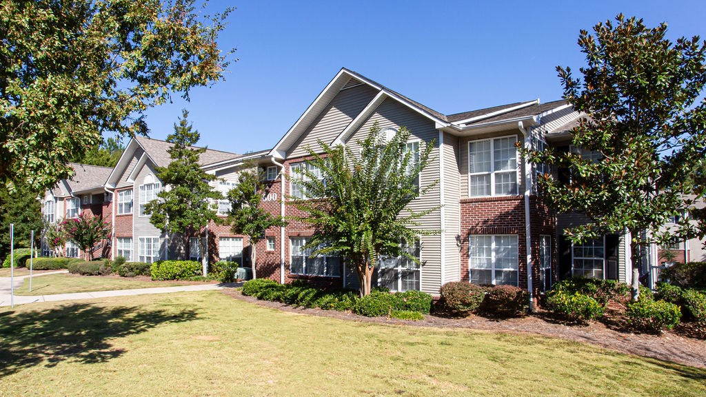 a row of houses with trees in front of them at Indigo Apartments Gainesville, Georgia