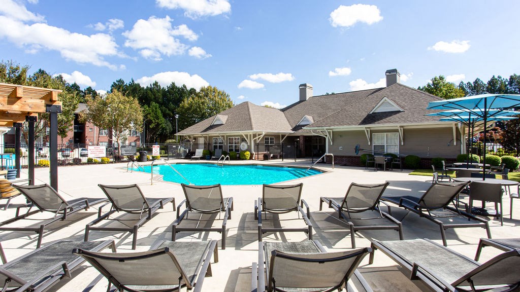 our apartments offer a pool and lounge area with chairs at Indigo Apartments Gainesville, Georgia