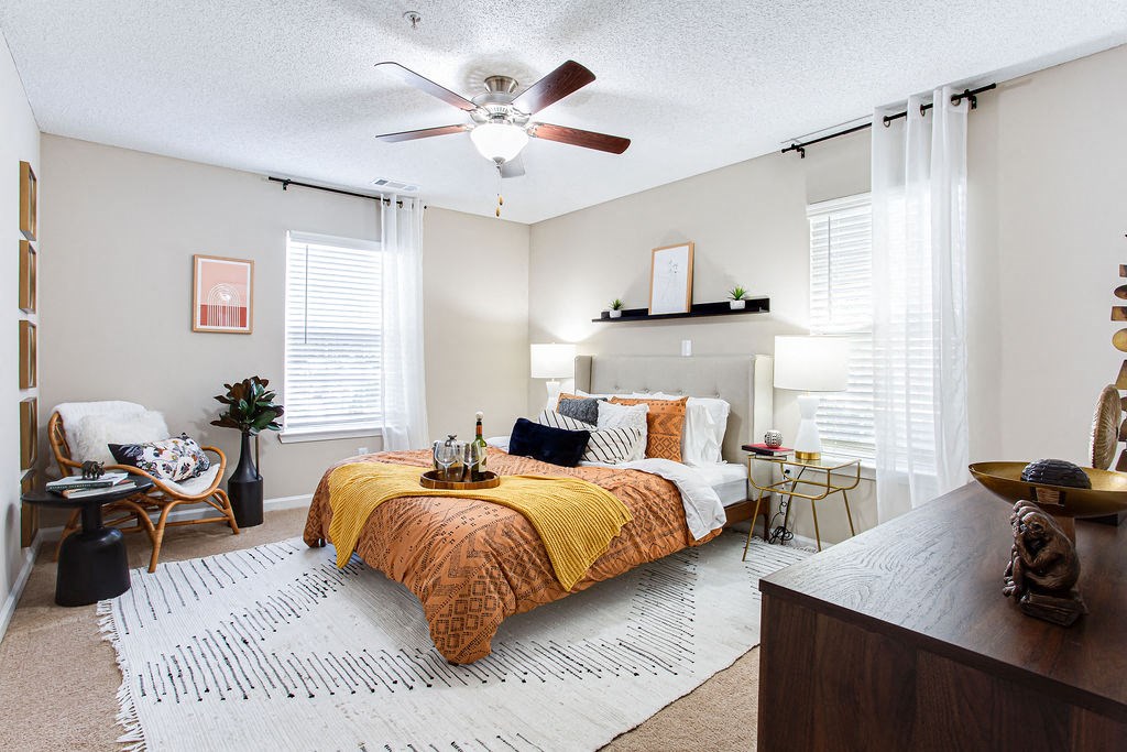 a bedroom with a bed and a ceiling fan at Indigo Apartments Gainesville, Gainesville, GA