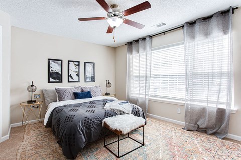 a bedroom with a bed and a ceiling fan at Indigo Apartments Gainesville, Gainesville, GA 30504