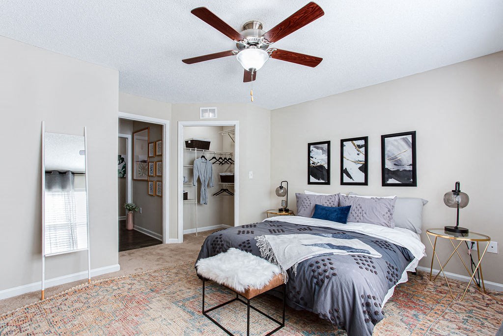 a bedroom with a bed and a ceiling fan at Indigo Apartments Gainesville, Gainesville, GA