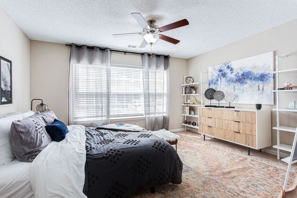 a bedroom with a bed and a ceiling fan at Indigo Apartments Gainesville, Gainesville, 30504