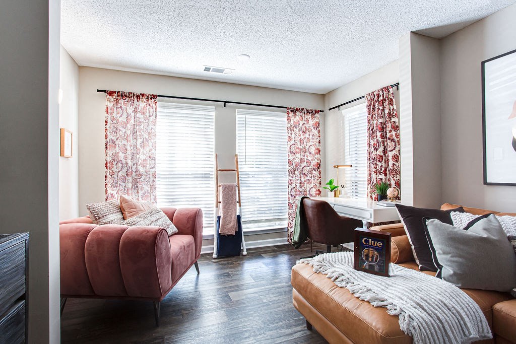 a living room with a couch and a table at Indigo Apartments Gainesville, Gainesville, 30504