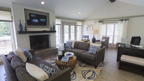 a living room with couches and a fireplace and a television