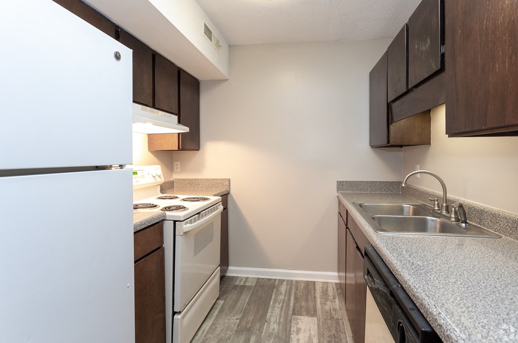 a kitchen at the whispering winds apartments in pearland at Tiffany Square, Rocky Mount