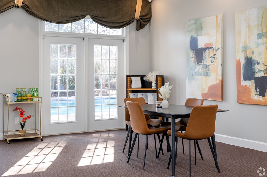 a dining room with a table and chairs and a window