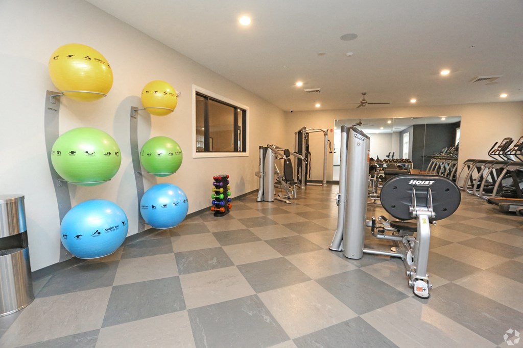 a gym with a bunch of exercise equipment and balloons on the floor at Century Baxter Avenue, Kentucky