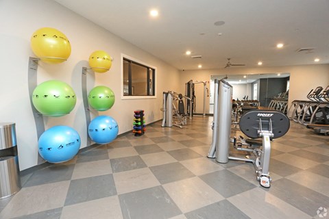 a gym with a bunch of exercise equipment and balloons on the floor at Century Baxter Avenue, Kentucky