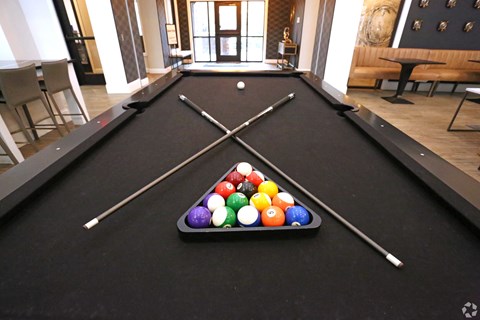a pool table with a bunch of balls on it at Century Baxter Avenue, Kentucky