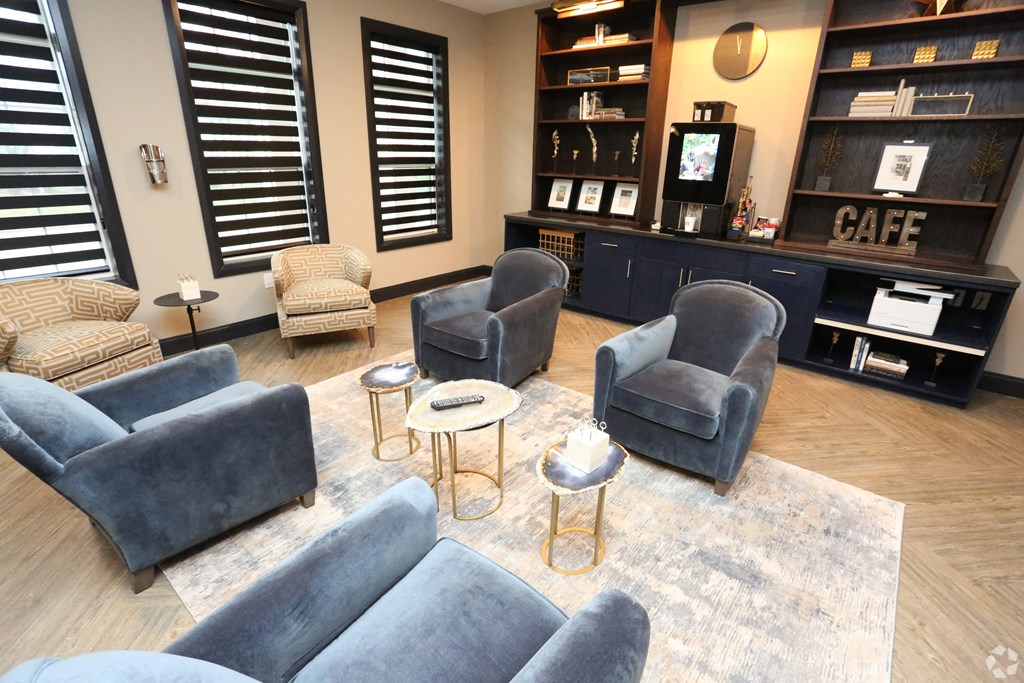 a living room with couches and chairs and a coffee table at Century Baxter Avenue, Louisville