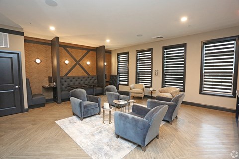 a living room with couches and chairs and a table at Century Baxter Avenue, Louisville, 40204