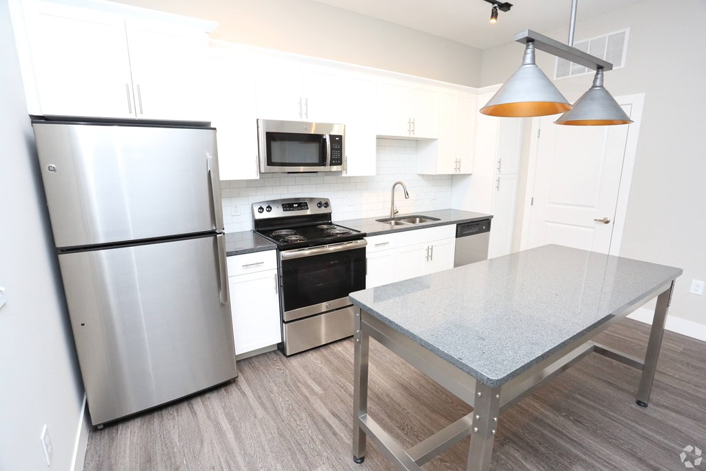 a kitchen with stainless steel appliances and a table at Century Baxter Avenue, Louisville, KY 40204