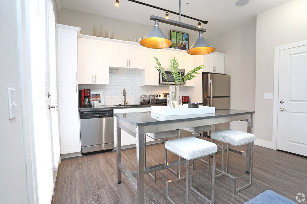 a kitchen with stainless steel appliances and a counter with stools at Century Baxter Avenue, Kentucky, 40204