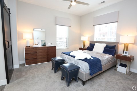 a bedroom with a bed and two night stands and a ceiling fan at Century Baxter Avenue, Louisville, KY
