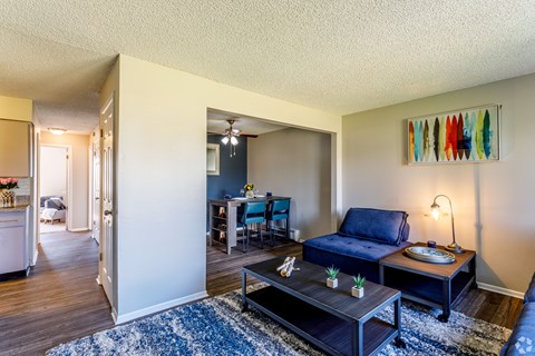 A living room with a blue couch and a coffee table.