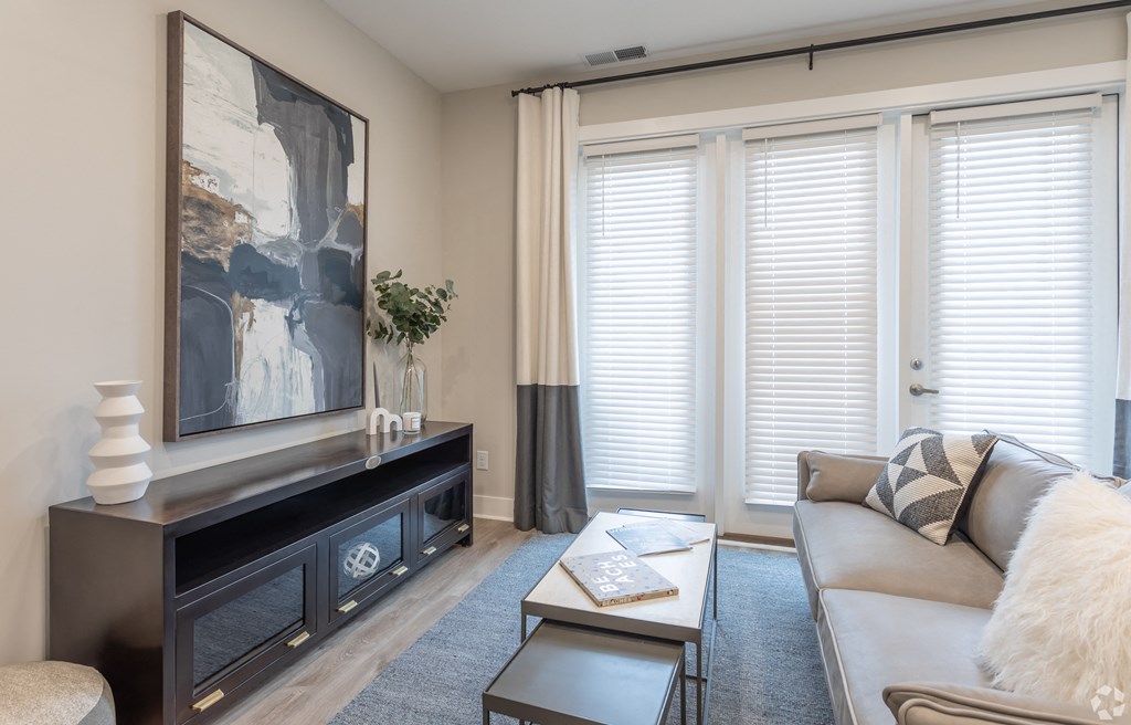 a living room with a couch and a fireplace and windows