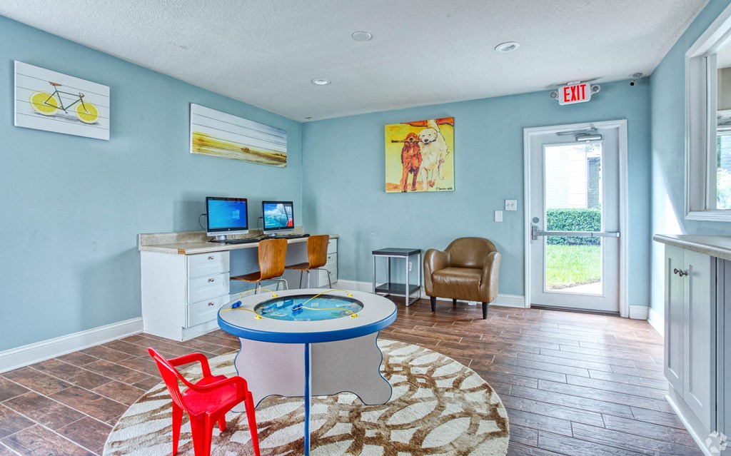 a play area with a pool table and chairs in a living room at The Essex, Altamonte Springs, FL