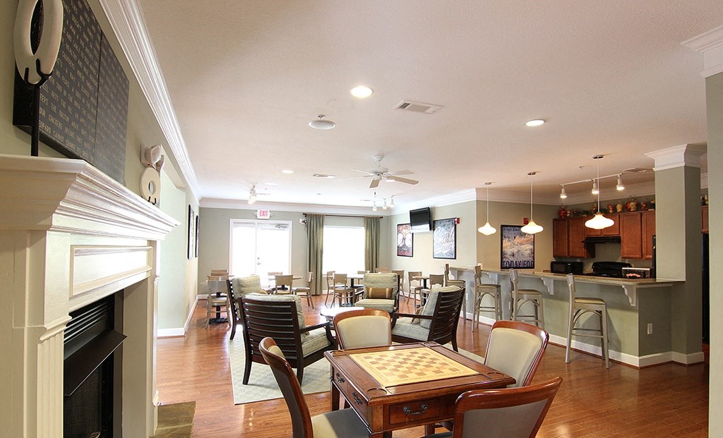 a room with a fireplace and tables and chairs