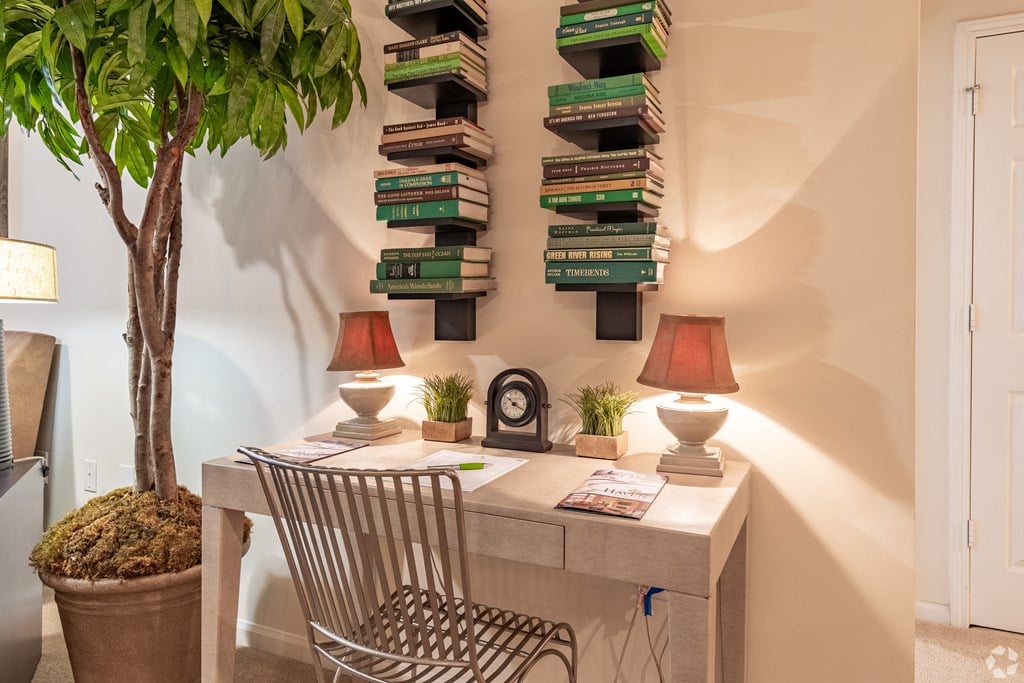 a desk with a chair and two lamps