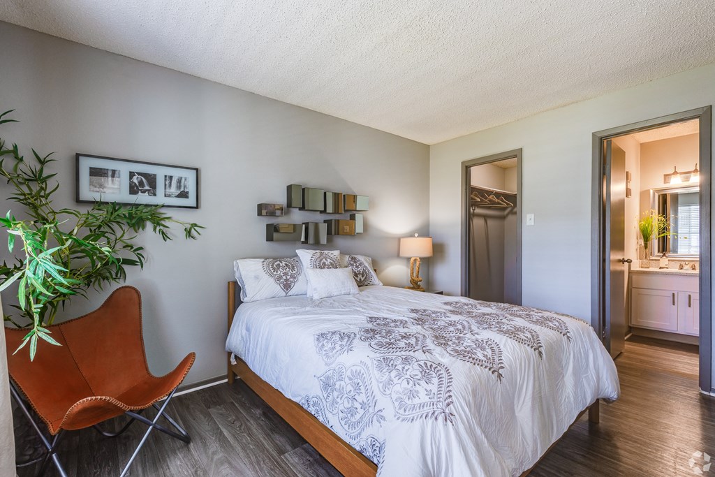a bedroom with a large bed and a chair at The Adelaide, Orlando