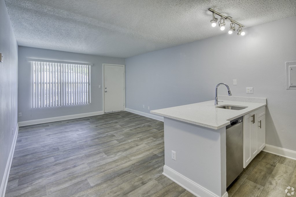 an empty kitchen and living room with a large window at Beach Club, Florida, 33614