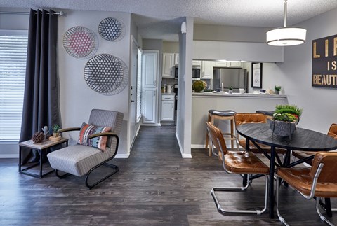A living room with a grey couch and a black table.