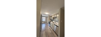 a kitchen with white cabinets and stainless steel appliances at Briarcliff at Quechee, Quechee, VT, 5059