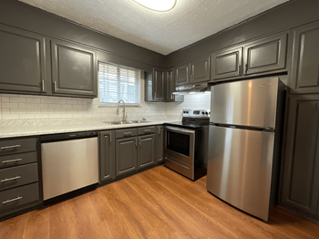 Fully Equipped Kitchen With Modern Appliances Fully Equipped Kitchen With Modern Appliances at The Woods on Tara Apartment Homes by ICER, Jonesboro - Photo Gallery 3