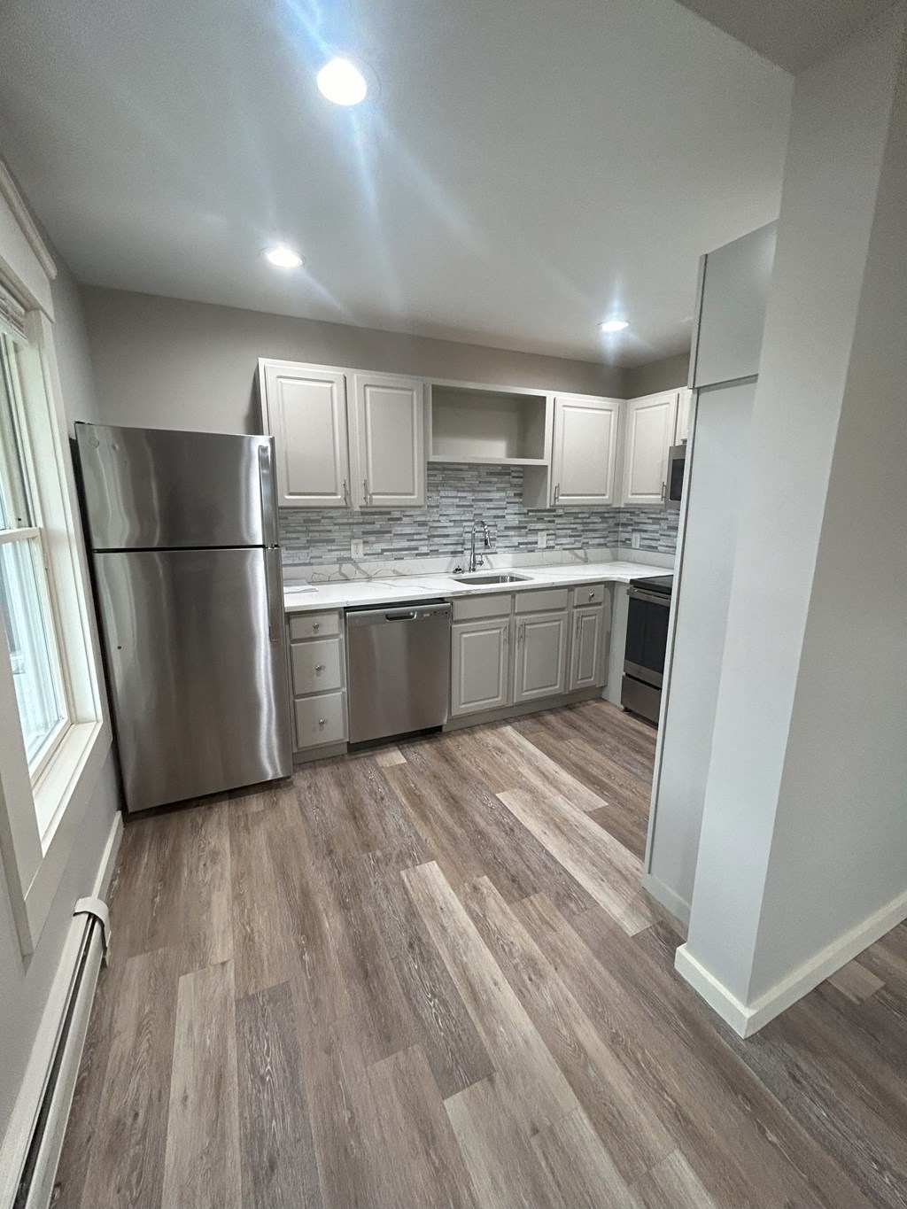 a kitchen with white cabinets and stainless steel appliances at Briarcliff at Quechee Apartments, Quechee, 05059