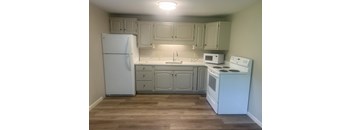 A kitchen with white appliances and wooden floors at Briarcliff at Quechee, Quechee, VT, Vermont  , 5059