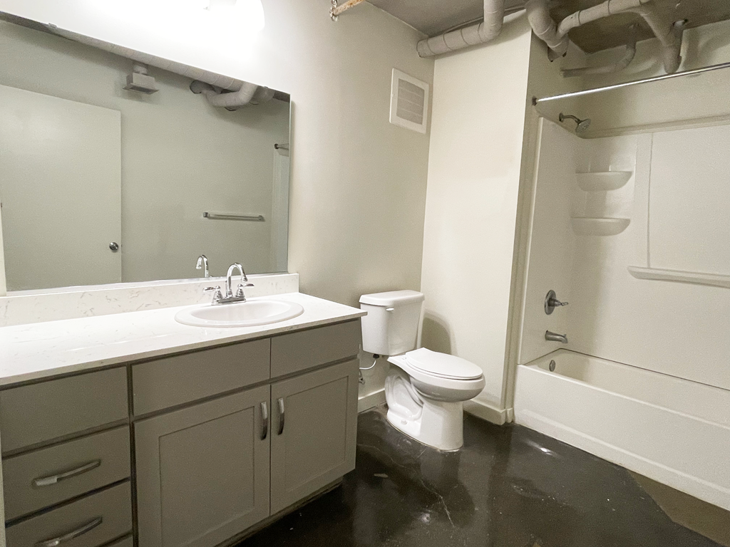 a bathroom with a sink toilet and shower