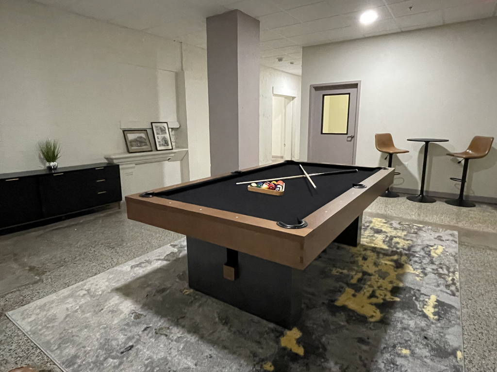 A game room with a pool table at Land Bank Lofts in Columbia, SC