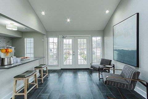 A kitchen with a bar area and a bench with a striped cushion.
