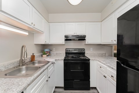 A modern kitchen with a black stove top oven.