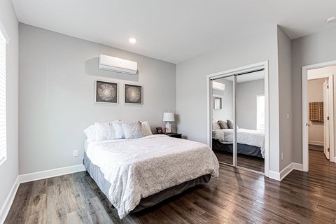 a bedroom with a bed and a mirror