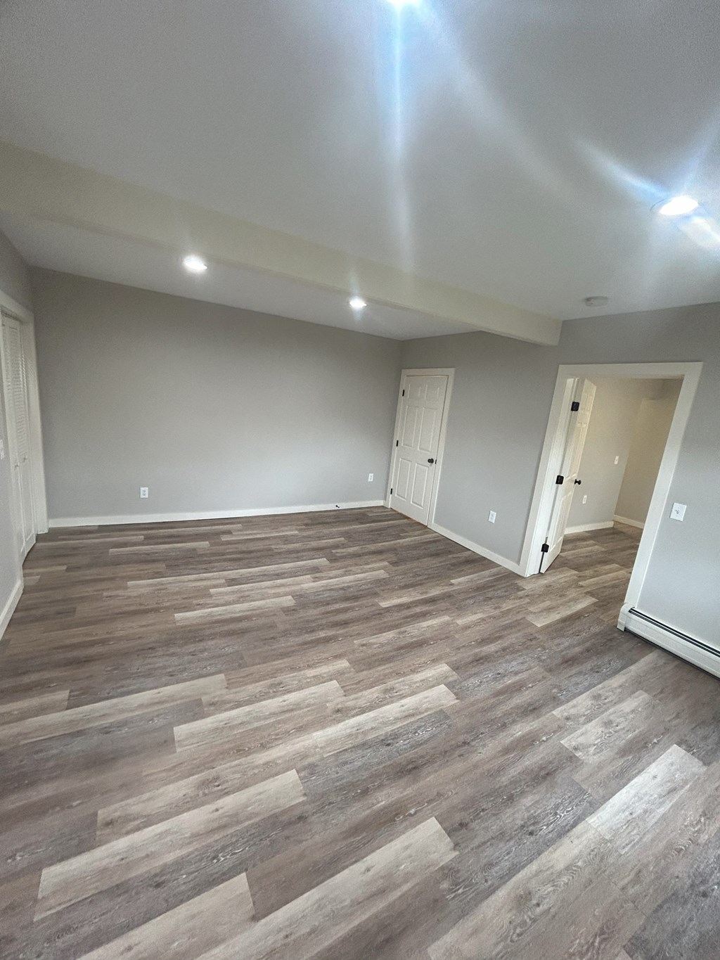 a living room with wood flooring and gray walls at Briarcliff at Quechee Apartments, Quechee