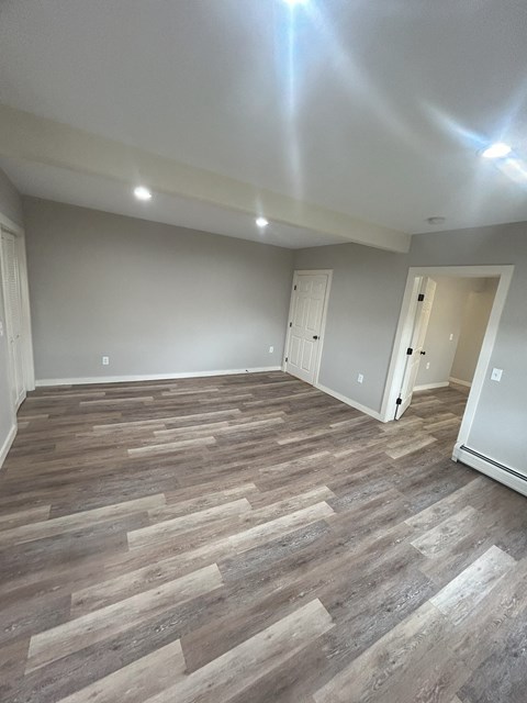 a living room with wood flooring and gray walls