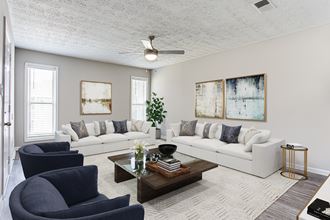 a living room with white couches and a coffee table