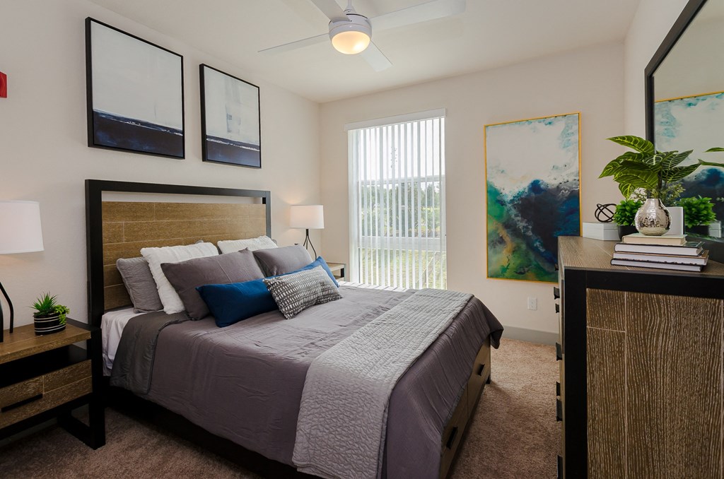 a bedroom with a large bed and a window at Lofts at South Lake, Florida, 34711