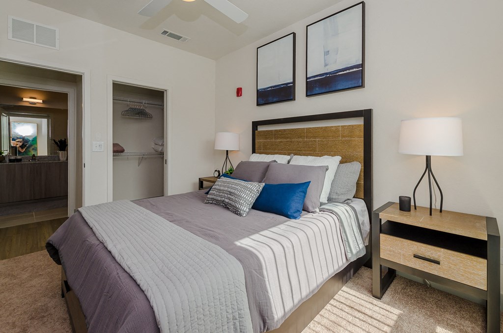 a bedroom with a bed and a dresser and a closet at Lofts at South Lake, Clermont, FL