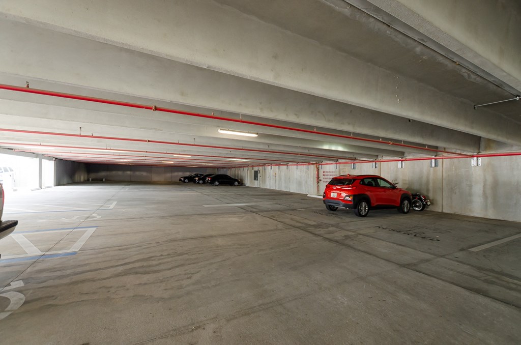 a red car parked in a parking garage at Lofts at South Lake, Clermont, FL, 34711