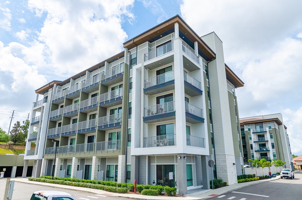 a large apartment building with balconies and cars parked outside at Lofts at South Lake, Florida