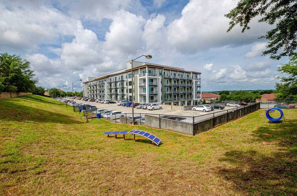 a building with a park in front of it and a parking lot at Lofts at South Lake, Clermont, FL, 34711