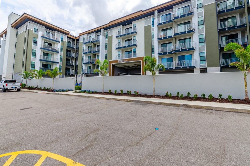 an empty parking lot in front of an apartment building at Lofts at South Lake, Clermont, FL, 34711