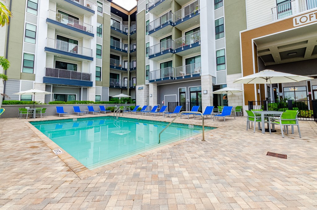 a swimming pool in front of an apartment building at Lofts at South Lake, Clermont, FL, 34711