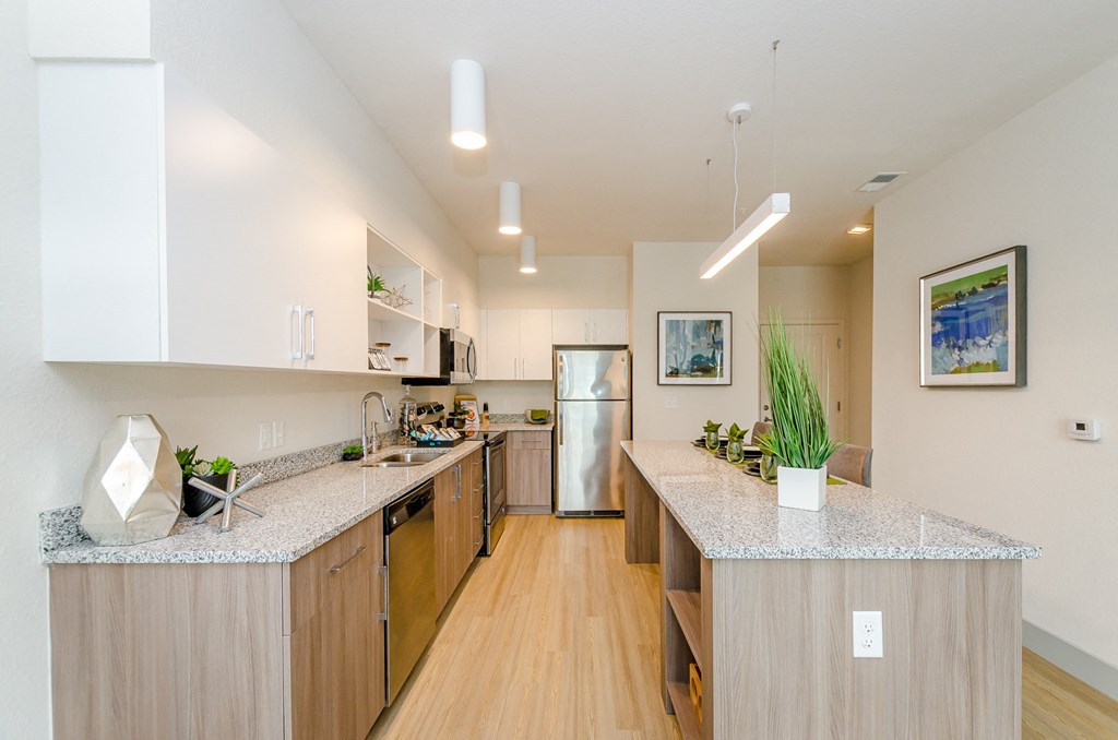 a view of a kitchen with a wood floor and counter tops at Lofts at South Lake, Clermont, 34711